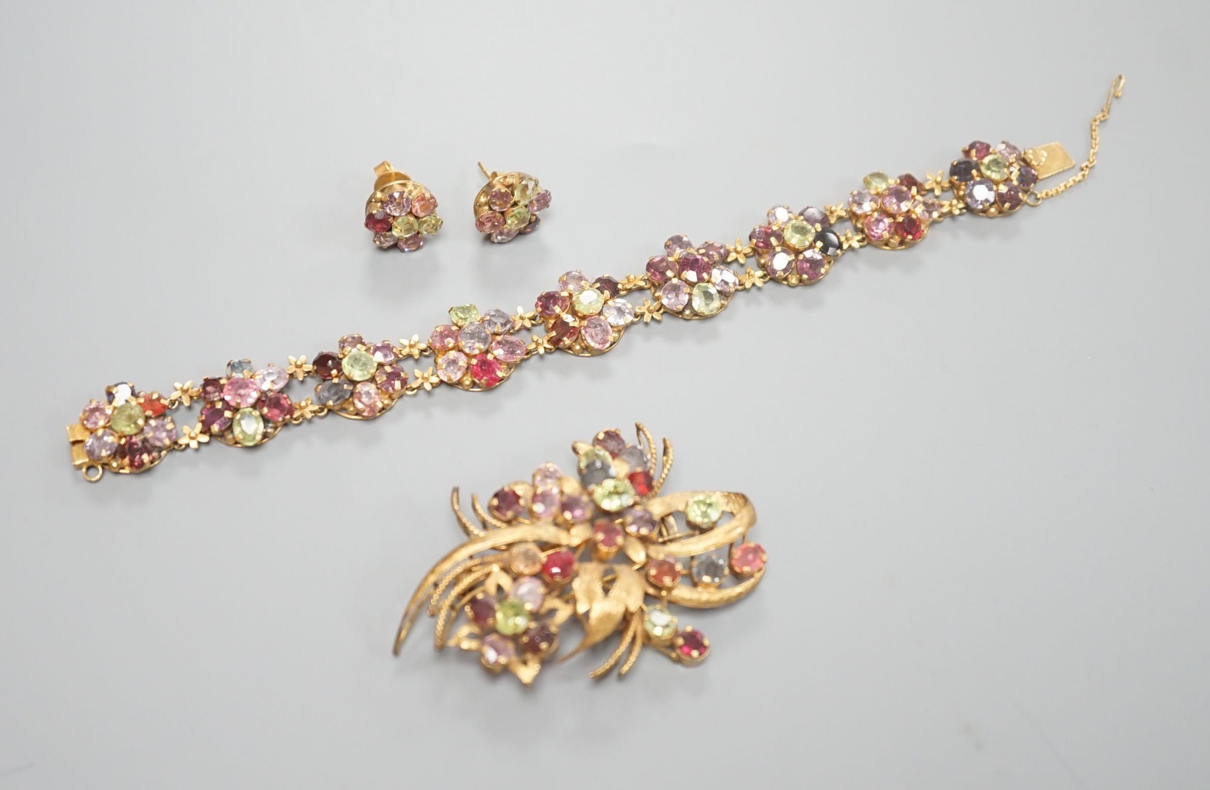 A gilt metal and coloured paste set bracelet and pair of earrings and a similar brooch, 6cm.